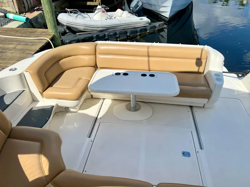 Slide: The Image of 2004 Sea Ray 46 SUNDANCER boat with tan leather seating and white table. - 3