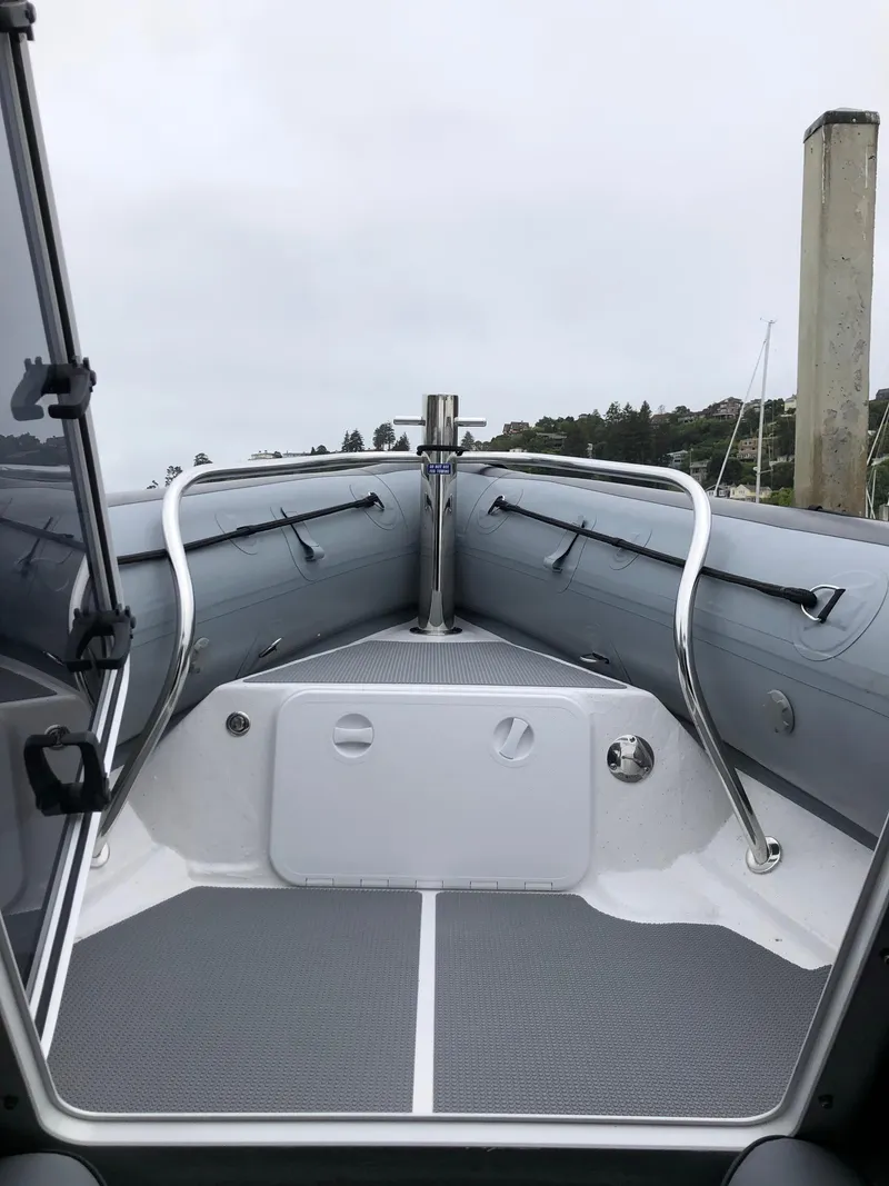 Slide: The Image of 2024 Protector 310 Targa boat interior with sleek design and stainless steel railings. - 10