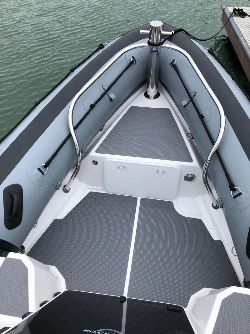 Slide: The Image of 2024 Protector 310 Targa boat interior, featuring sleek design and durable materials on calm water. - 11