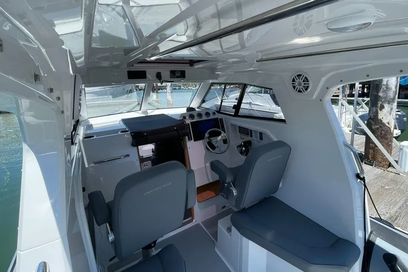 Slide: The Image of 2024 Protector 310 Targa boat interior with modern helm and seating. - 5