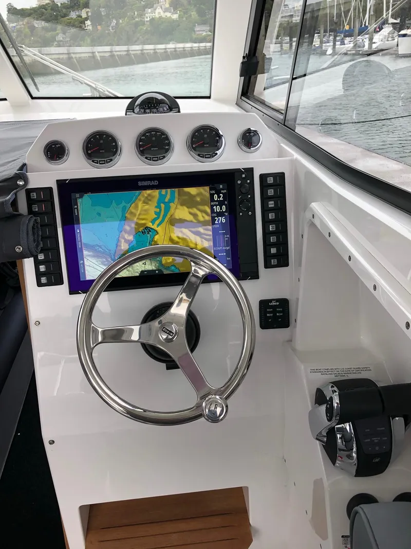 Slide: The Image of 2024 Protector 310 Targa boat dashboard with navigation system and controls. - 8