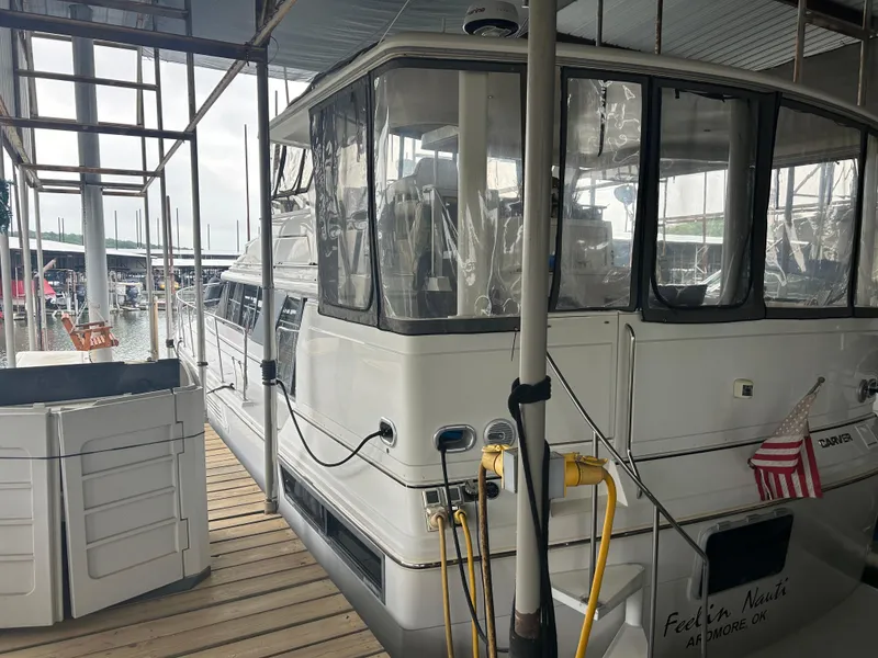 Slide: The Image of 1996 Carver 440 Aft Cabin Motor Yacht docked at marina, side view. - 2