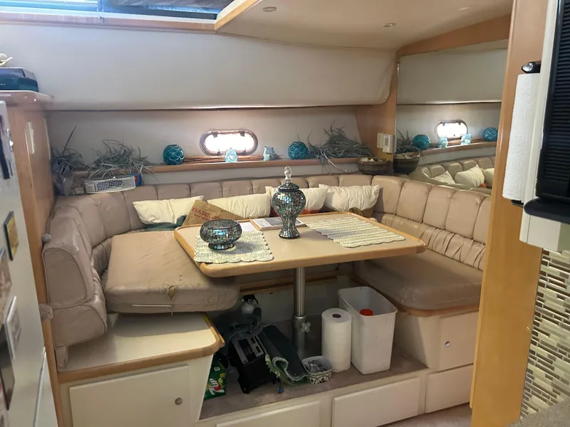 Slide: The Image of 1996 Carver 440 Aft Cabin Motor Yacht interior with cozy dining area and decorative accents. - 21