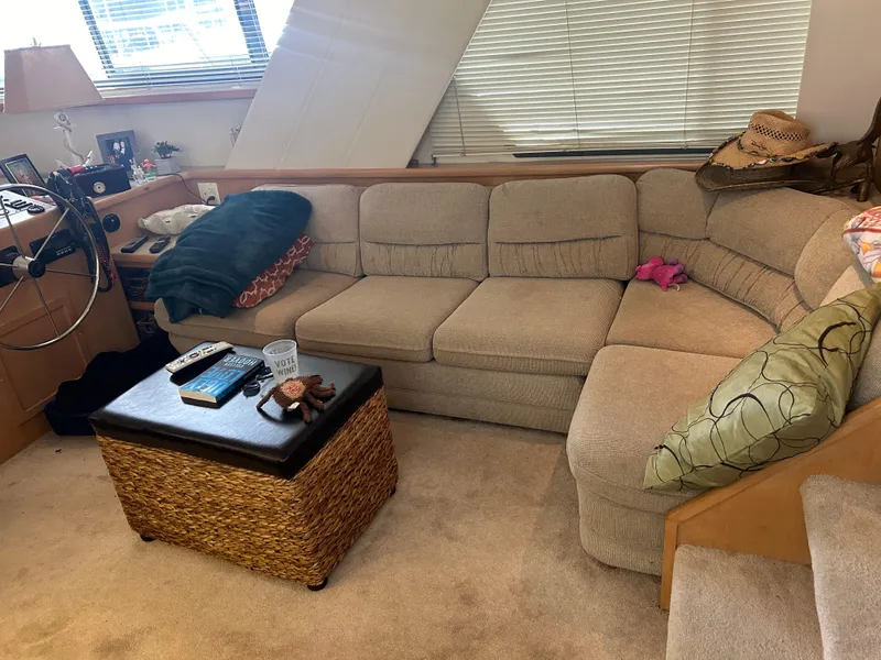 Slide: The Image of Cozy interior of 1996 Carver 440 Aft Cabin Motor Yacht with beige sofa and wicker table. - 25