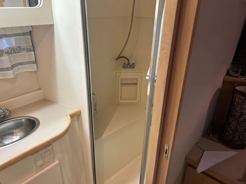 Slide: The Image of 1996 Carver 440 Aft Cabin Motor Yacht bathroom with shower and sink. - 28
