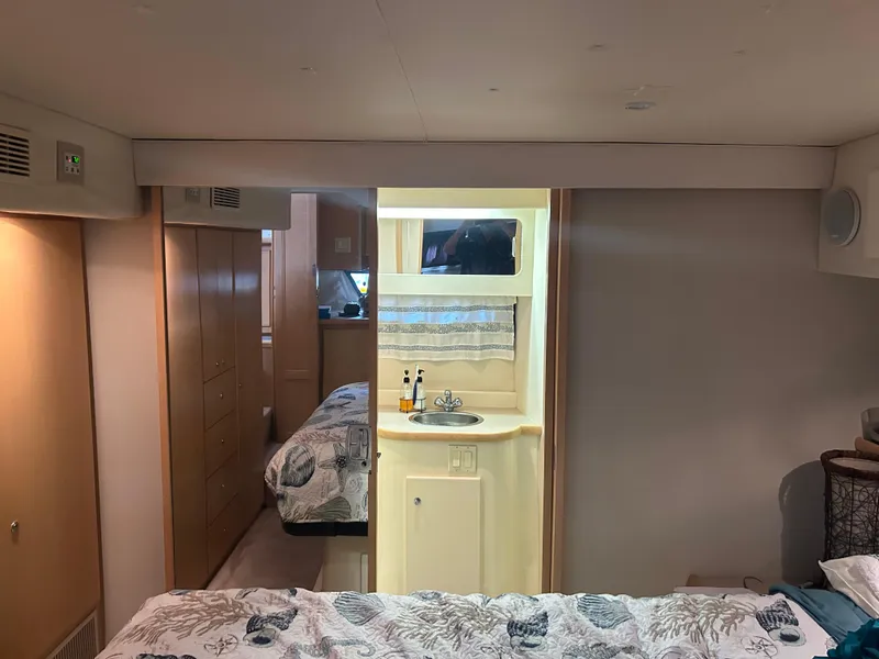 Slide: The Image of 1996 Carver 440 Aft Cabin Motor Yacht interior with cozy bedroom and compact sink area. - 31