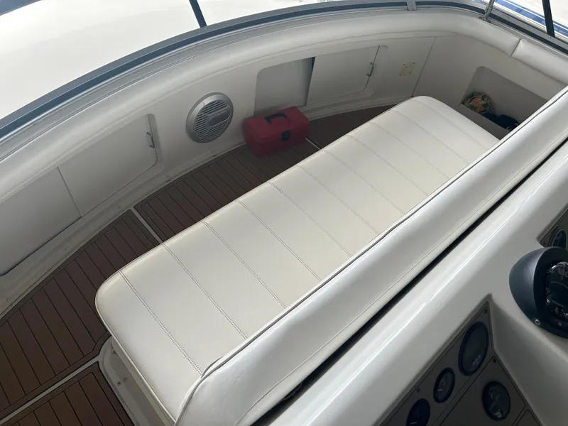Slide: The Image of 1996 Carver 440 Aft Cabin Motor Yacht interior with white seating and wood flooring. - 36