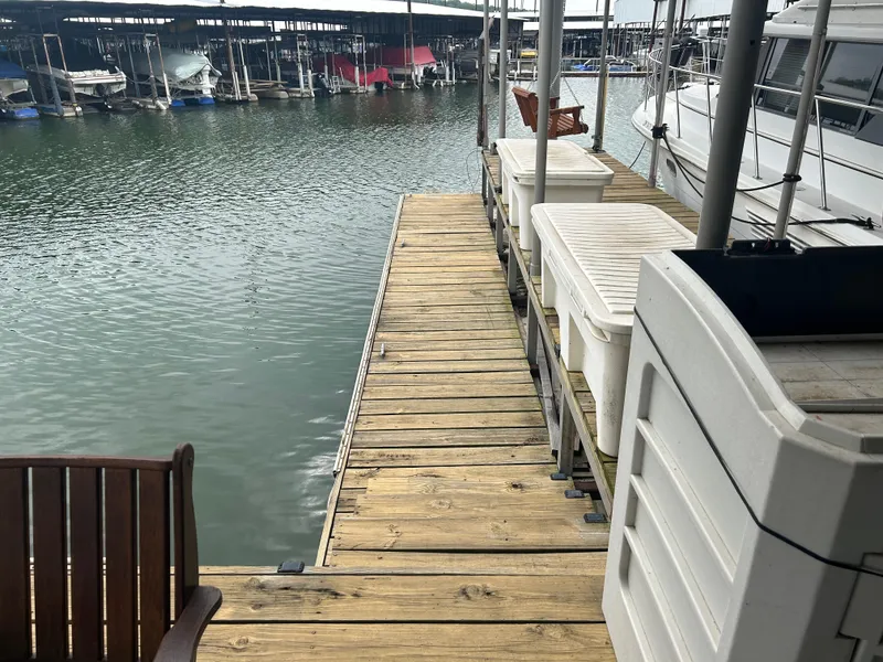 Slide: The Image of Wooden dock beside Carver 440 Aft Cabin Motor Yacht, 1996, at marina with boats. - 7