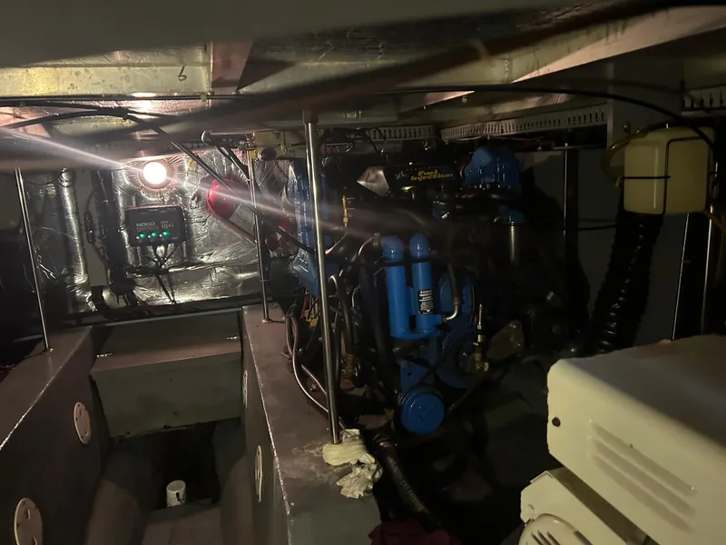 Slide: The Image of Engine room of a 1996 Carver 440 Aft Cabin Motor Yacht, featuring mechanical components. - 14