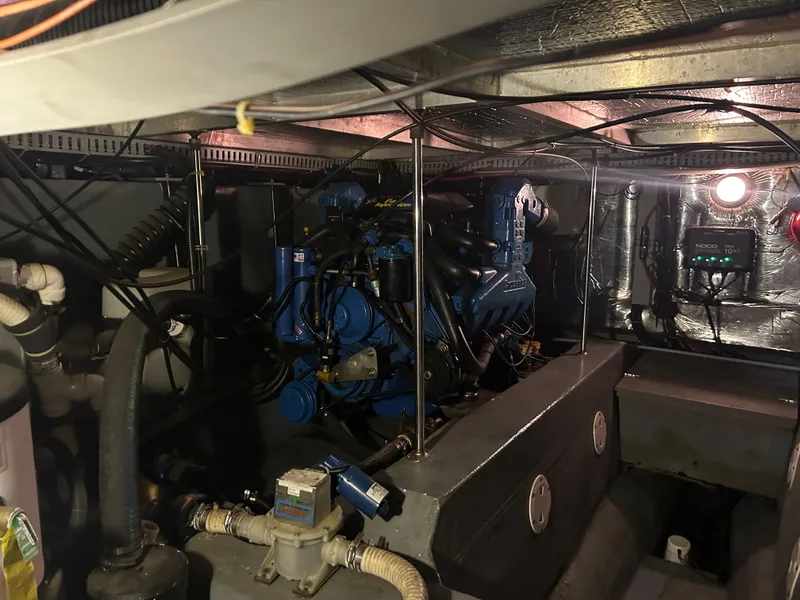 Slide: The Image of Engine room of 1996 Carver 440 Aft Cabin Motor Yacht, showcasing mechanical components. - 15