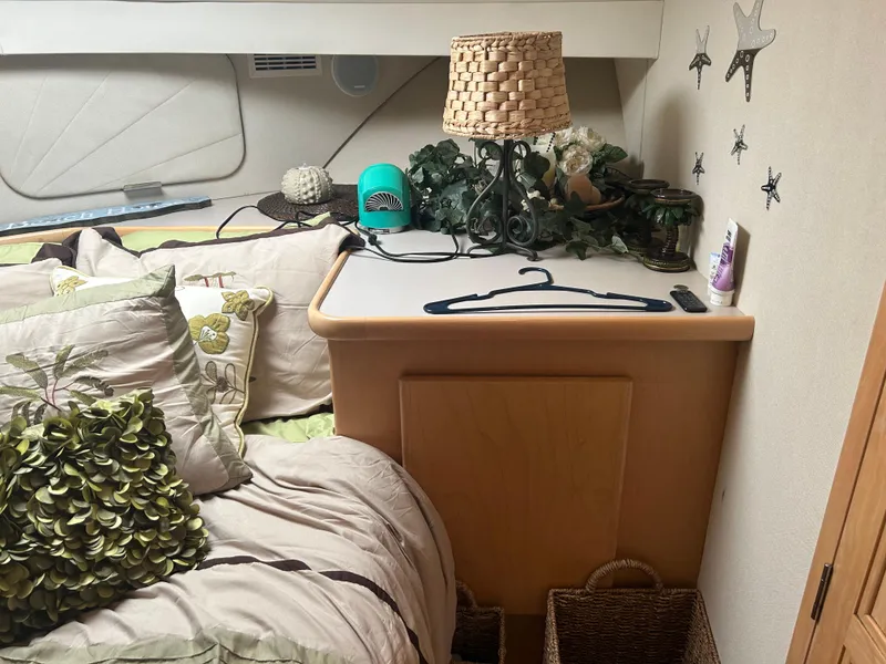 Slide: The Image of Cozy bedroom interior of 1996 Carver 440 Aft Cabin Motor Yacht with decorative elements. - 16