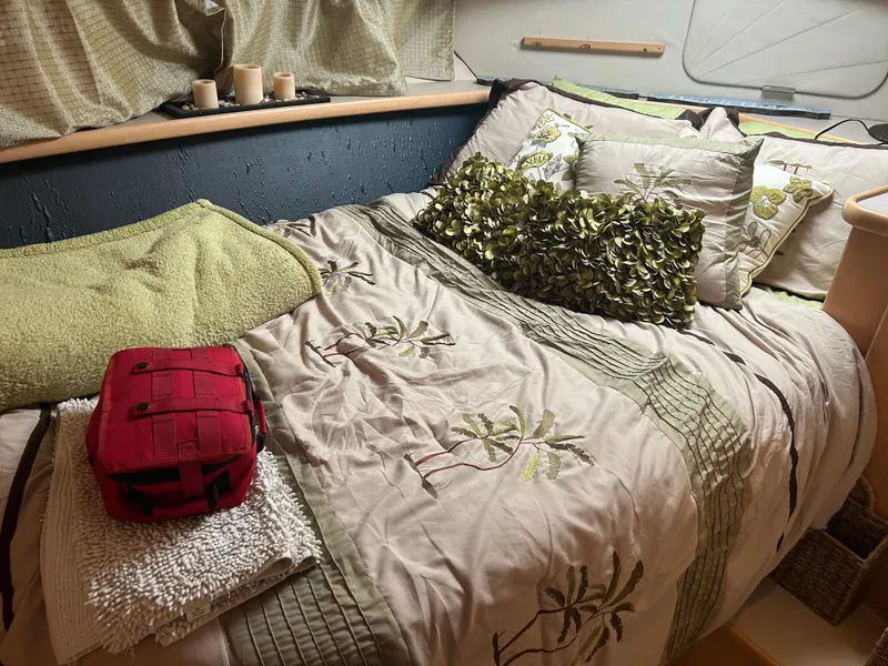 Slide: The Image of Cozy bedroom in 1996 Carver 440 Aft Cabin Motor Yacht with decorative pillows and a red bag. - 17