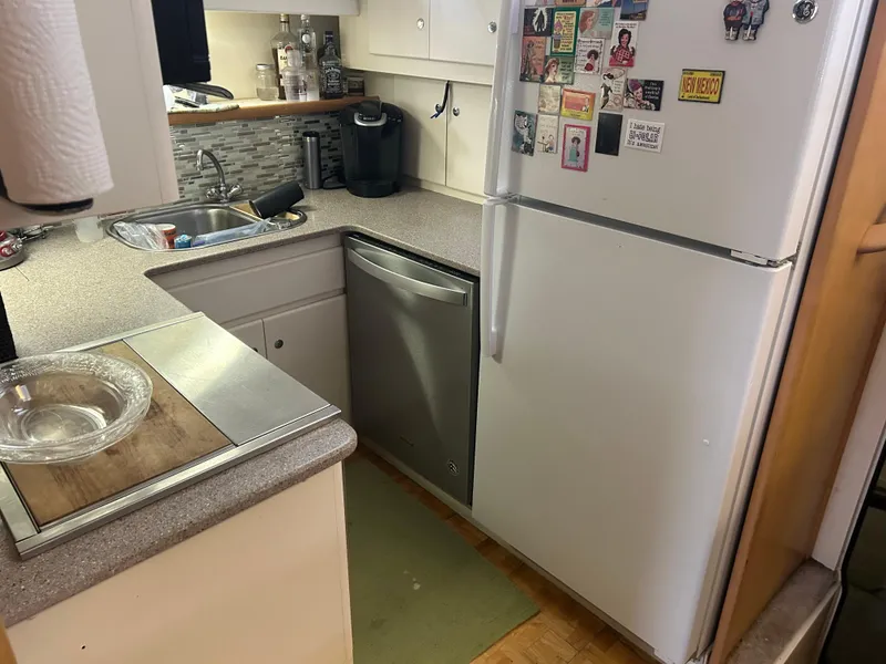 Slide: The Image of Compact kitchen in a 1996 Carver 440 Aft Cabin Motor Yacht with modern appliances. - 22