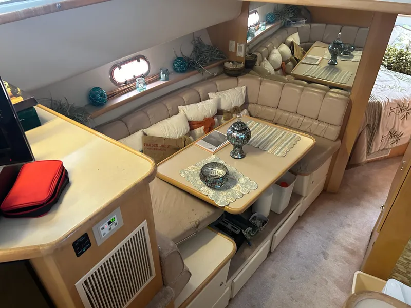 Slide: The Image of 1996 Carver 440 Aft Cabin Motor Yacht interior with cozy seating and elegant decor. - 23