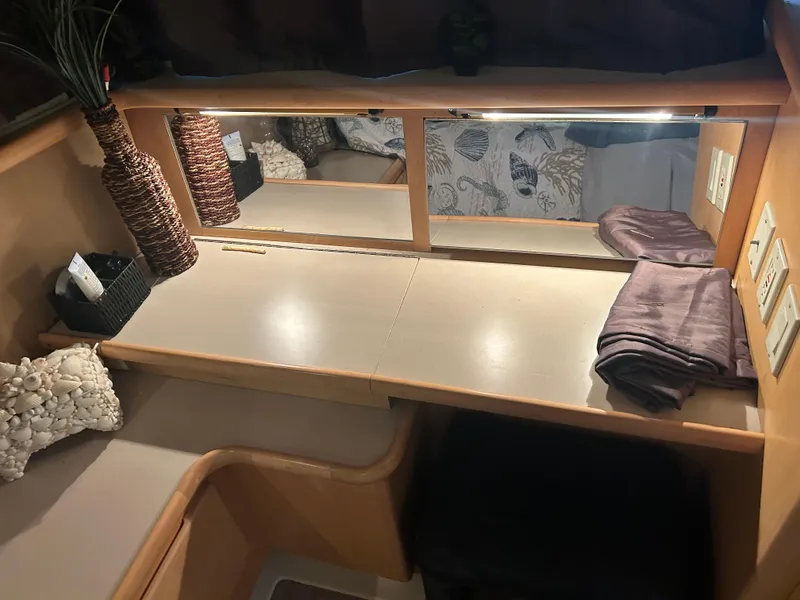 Slide: The Image of 1996 Carver 440 Aft Cabin Motor Yacht interior with vanity, mirror, and decorative elements. - 29