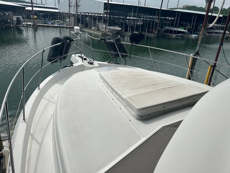 Slide: The Image of 1996 Carver 440 Aft Cabin Motor Yacht docked at marina, featuring spacious deck area. - 3