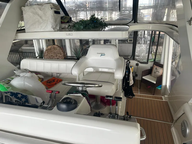 Slide: The Image of 1996 Carver 440 Aft Cabin Motor Yacht interior with helm and seating area. - 34