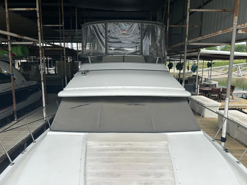 Slide: The Image of 1996 Carver 440 Aft Cabin Motor Yacht docked under shelter. - 35