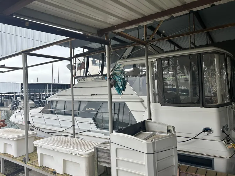 Slide: The Image of 1996 Carver 440 Aft Cabin Motor Yacht docked in a marina. - 38