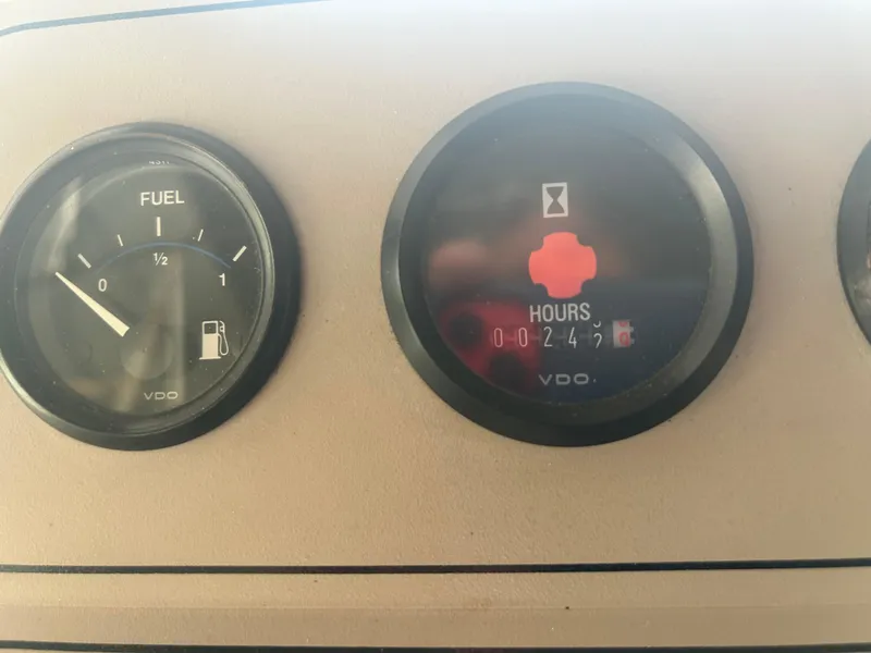 Slide: The Image of Dashboard gauges of a 1996 Carver 440 Aft Cabin Motor Yacht showing fuel and engine hours. - 41