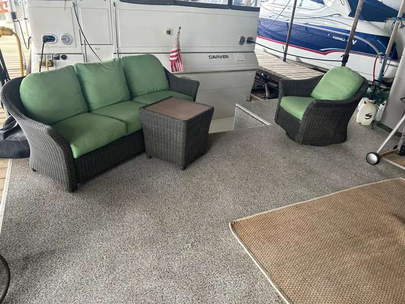 Slide: The Image of 1996 Carver 440 Aft Cabin Motor Yacht with outdoor seating and green cushions. - 45