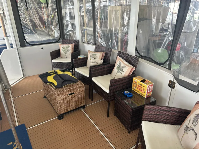 Slide: The Image of 1996 Carver 440 Aft Cabin Motor Yacht interior with wicker seating and nautical decor. - 47