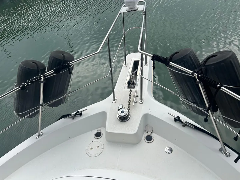 Slide: The Image of Bow of 1996 Carver 440 Aft Cabin Motor Yacht with fenders and anchor chain. - 48