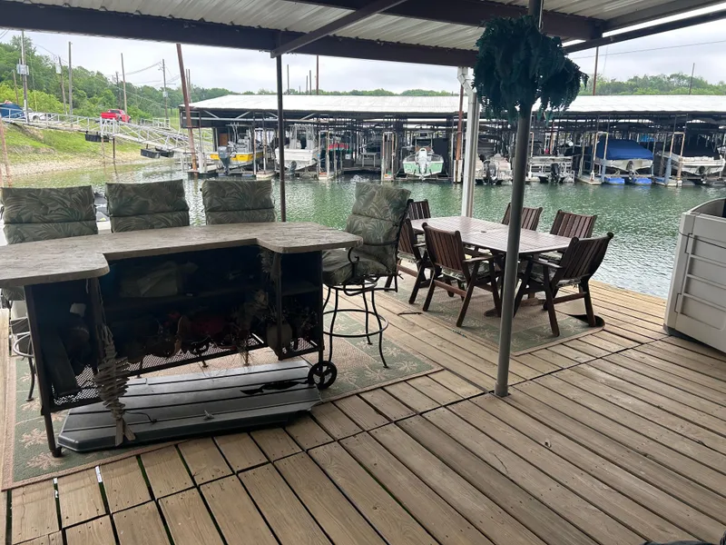 Slide: The Image of Covered dock with seating area overlooking marina, featuring Carver 440 Aft Cabin Motor Yacht, 1996. - 8