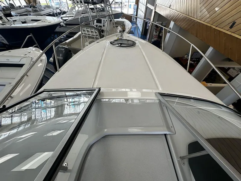 Slide: The Image of 2024 Regal 26XO boat interior view with open hatch and sleek design. - 1