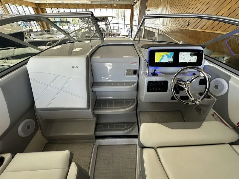 Slide: The Image of 2024 Regal 26XO boat interior with modern helm, touchscreen display, and comfortable seating. - 11