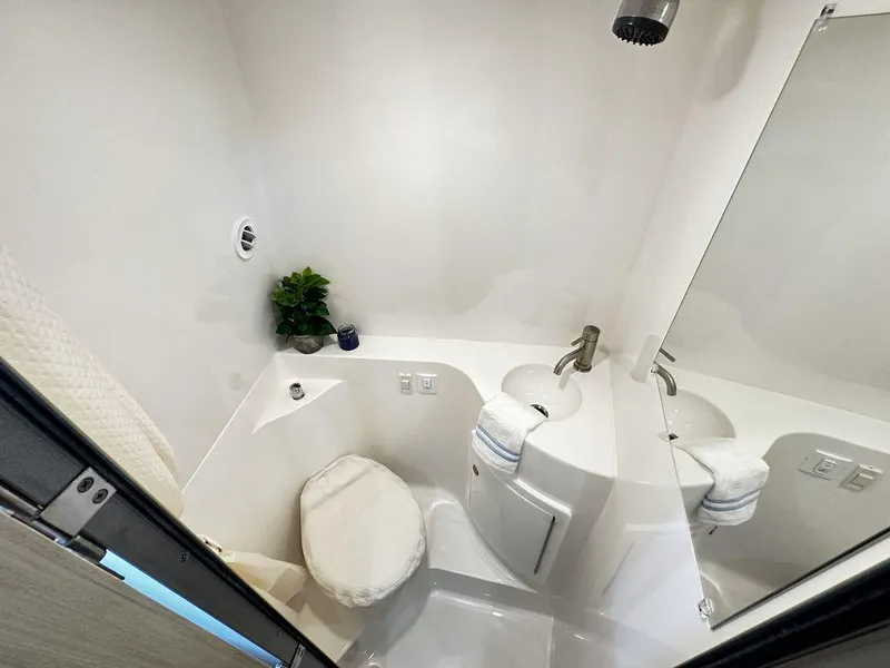 Slide: The Image of 2024 Regal 26XO boat bathroom with modern fixtures and compact design. - 15