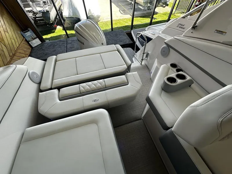 Slide: The Image of Interior of 2024 Regal 26XO boat with white leather seating and cup holders. - 2