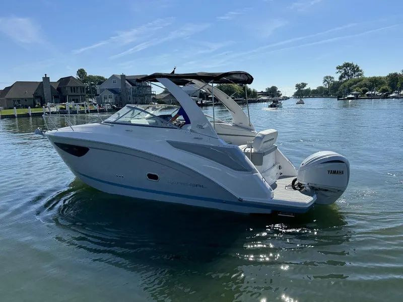 Slide: The Image of 2024 Regal 26XO boat on a sunny lake with Yamaha outboard motor. - 21