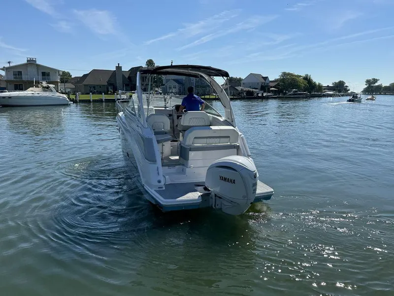 Slide: The Image of 2024 Regal 26XO boat with Yamaha engine on a sunny lake. - 24