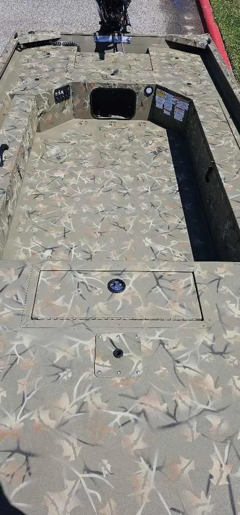 Slide: The Image of 2024 Tracker Grizzly 1654 T Sportsman boat with camo pattern interior. - 4