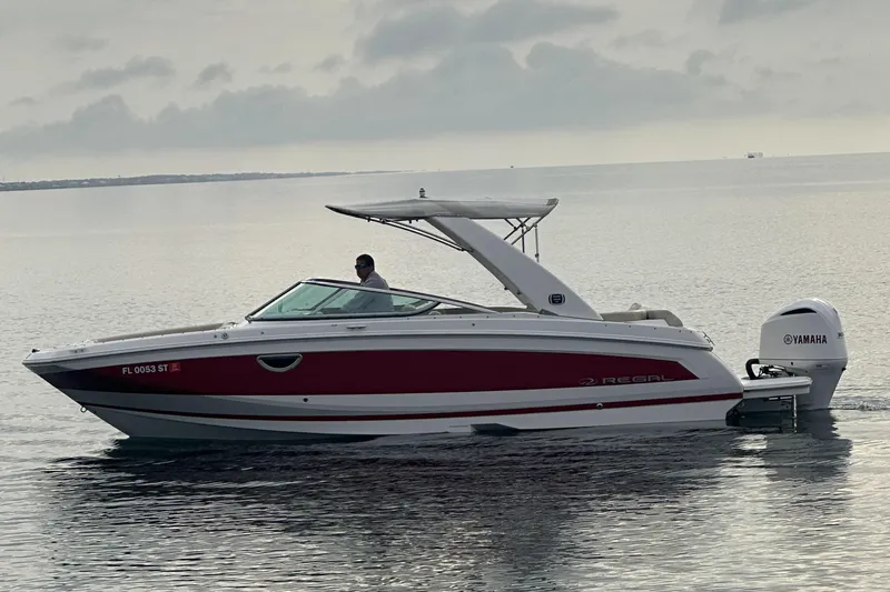 Slide: The Image of 2019 Regal 26 OBX boat with Yamaha outboard motor on calm water. - 11