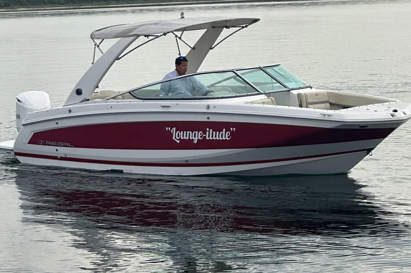 Slide: The Image of 2019 Regal 26 OBX boat named Lounge-titude cruising on calm water. - 12