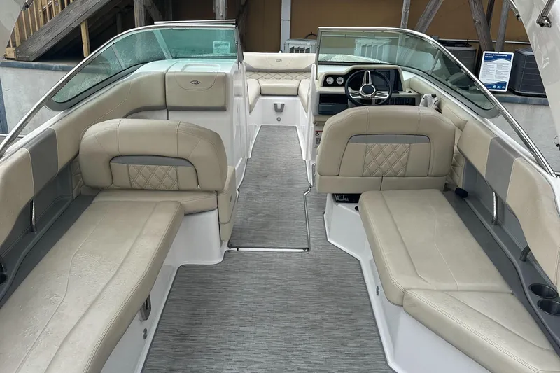 Slide: The Image of 2019 Regal 26 OBX boat interior with beige seating and modern dashboard. - 2