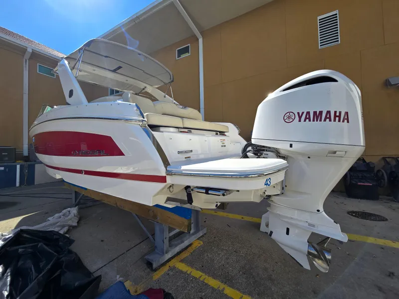 Slide: The Image of 2019 Regal 26 OBX boat with Yamaha outboard motor, docked outdoors. - 21