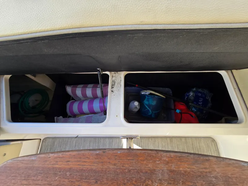Slide: The Image of Storage compartments in a 2019 Regal 26 OBX boat, containing various items. - 29