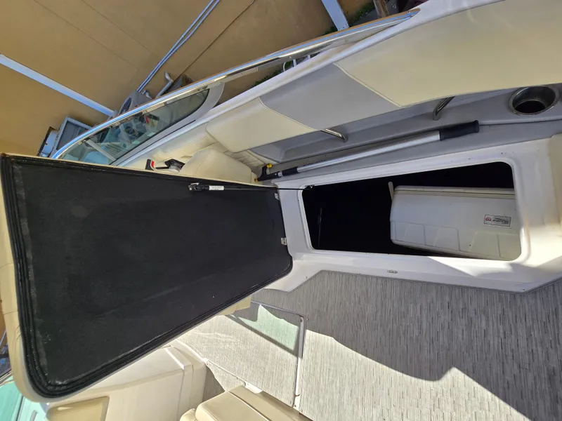 Slide: The Image of 2019 Regal 26 OBX boat interior storage compartment open. - 30