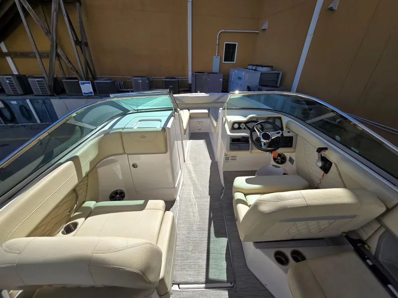 Slide: The Image of 2019 Regal 26 OBX boat interior with beige seating and modern dashboard. - 31