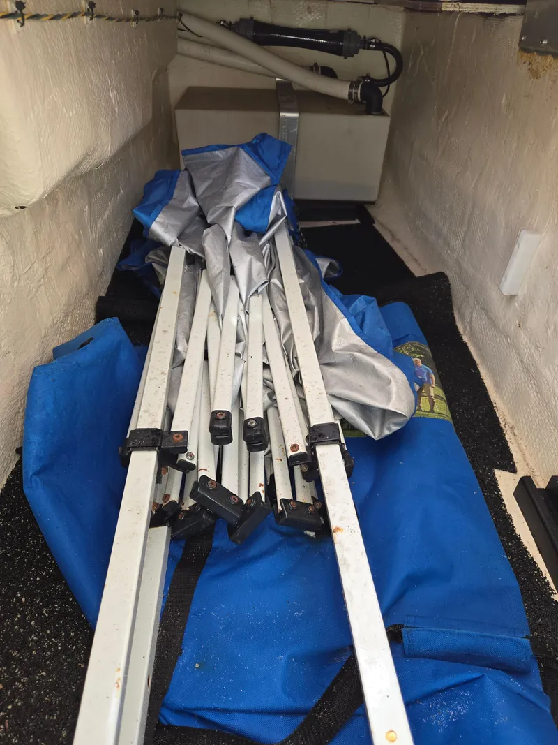 Slide: The Image of Storage compartment of 2019 Regal 26 OBX boat with folded canopy and metal frame. - 36