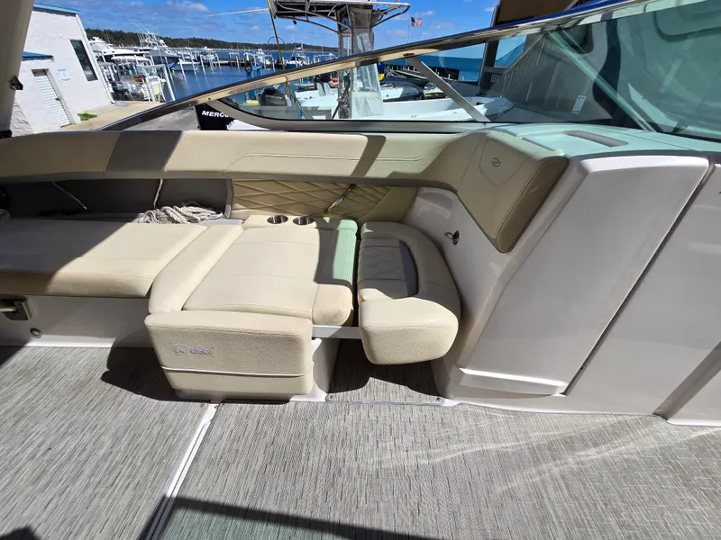 Slide: The Image of 2019 Regal 26 OBX boat interior with beige seating and cup holders. - 39