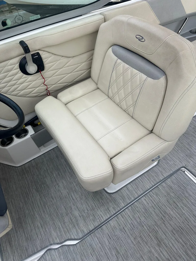 Slide: The Image of Captain's seat of a 2019 Regal 26 OBX boat with beige upholstery. - 4