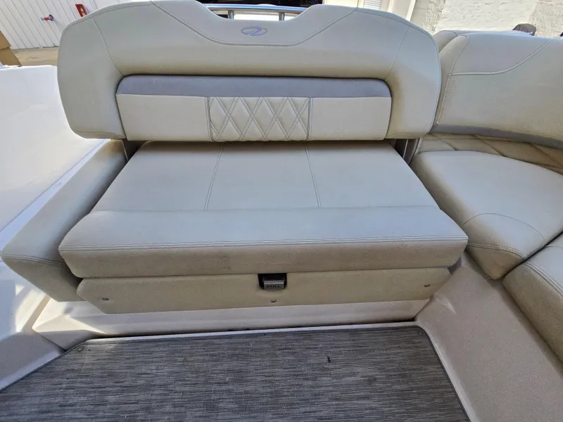 Slide: The Image of 2019 Regal 26 OBX boat interior seating with beige upholstery and diamond stitching. - 40