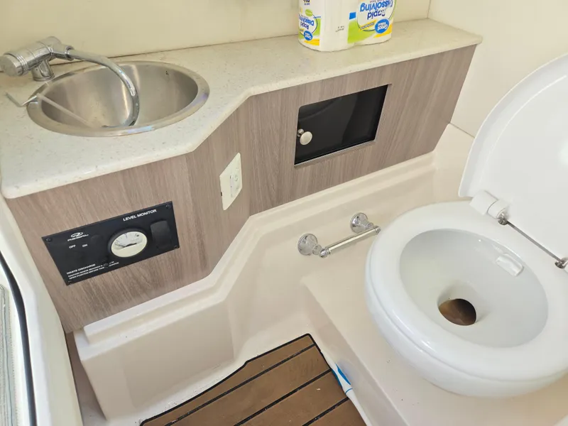 Slide: The Image of 2019 Regal 26 OBX boat bathroom with sink and toilet. - 43