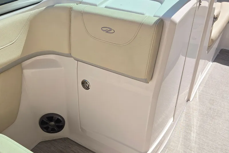 Slide: The Image of 2019 Regal 26 OBX boat interior with beige seating and storage compartment. - 44