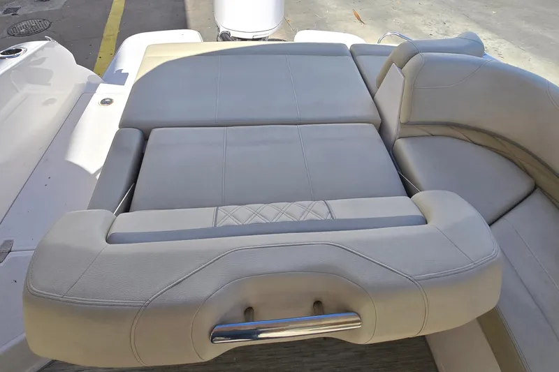 Slide: The Image of 2019 Regal 26 OBX boat interior seating with beige upholstery and stainless steel handle. - 45