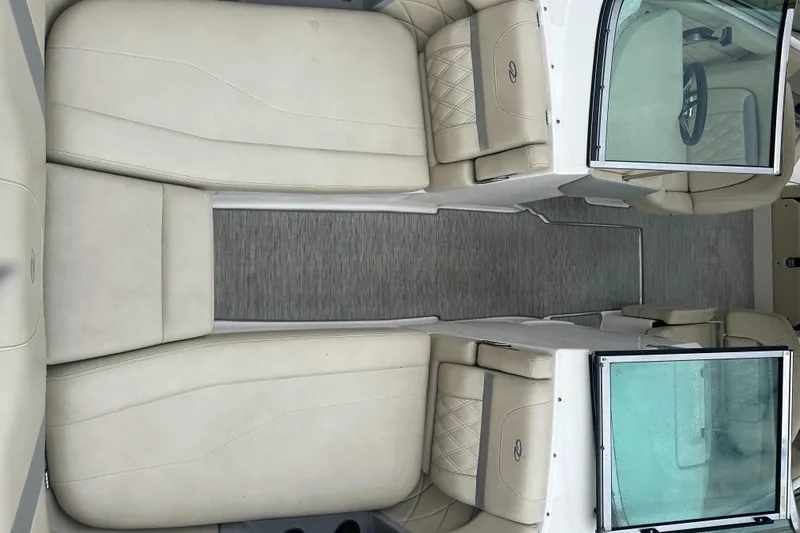 Slide: The Image of 2019 Regal 26 OBX boat interior with beige seating and gray flooring. - 7